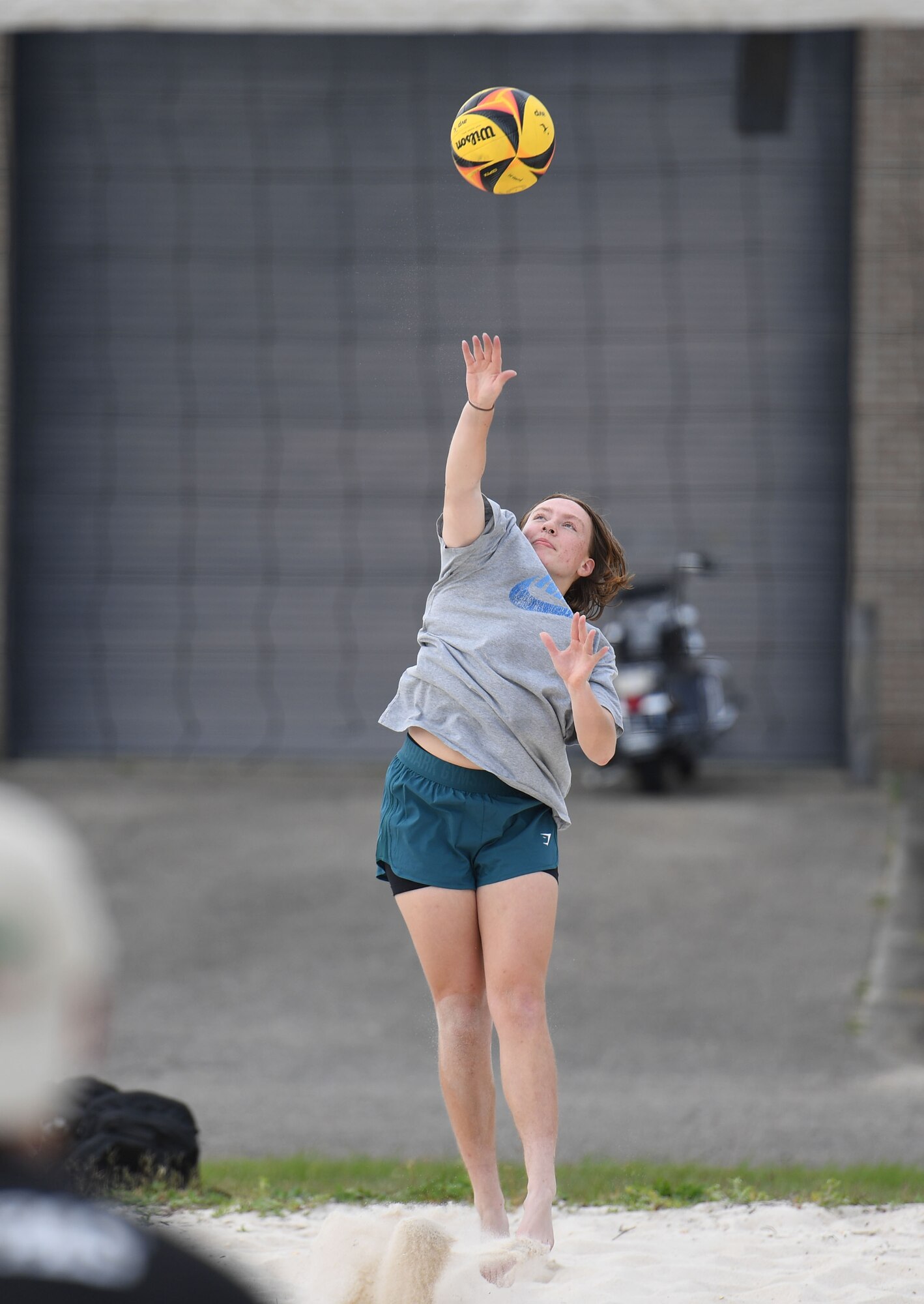 U.S. Air Force Airman 1st Class Erin Scott, 338th Training Squadron student, serves a volleyball during the Sexual Assault and Awareness Prevention Month volleyball tournament at Keesler Air Force Base, Mississippi, April 29, 2022. More than 20 teams competed in the event, which was held in acknowledgment of Sexual Assault and Awareness Prevention Month throughout April. (U.S. Air Force photo by Kemberly Groue)