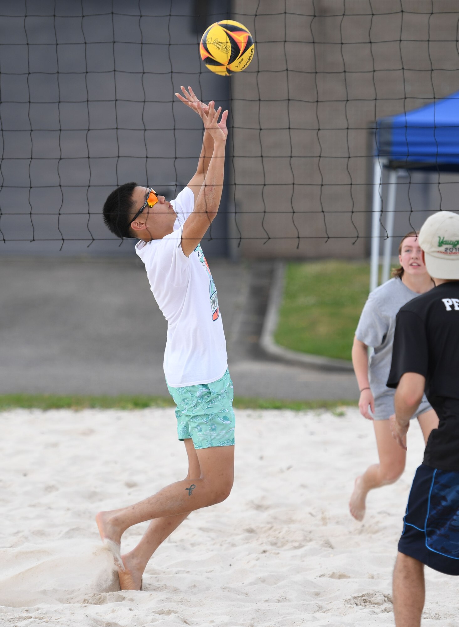 U.S. Air Force Airman Andre Phamhoang, 336th Training Squadron student, hits a volleyball during the Sexual Assault and Awareness Prevention Month volleyball tournament at Keesler Air Force Base, Mississippi, April 29, 2022. More than 20 teams competed in the event, which was held in acknowledgment of Sexual Assault and Awareness Prevention Month throughout April. (U.S. Air Force photo by Kemberly Groue)