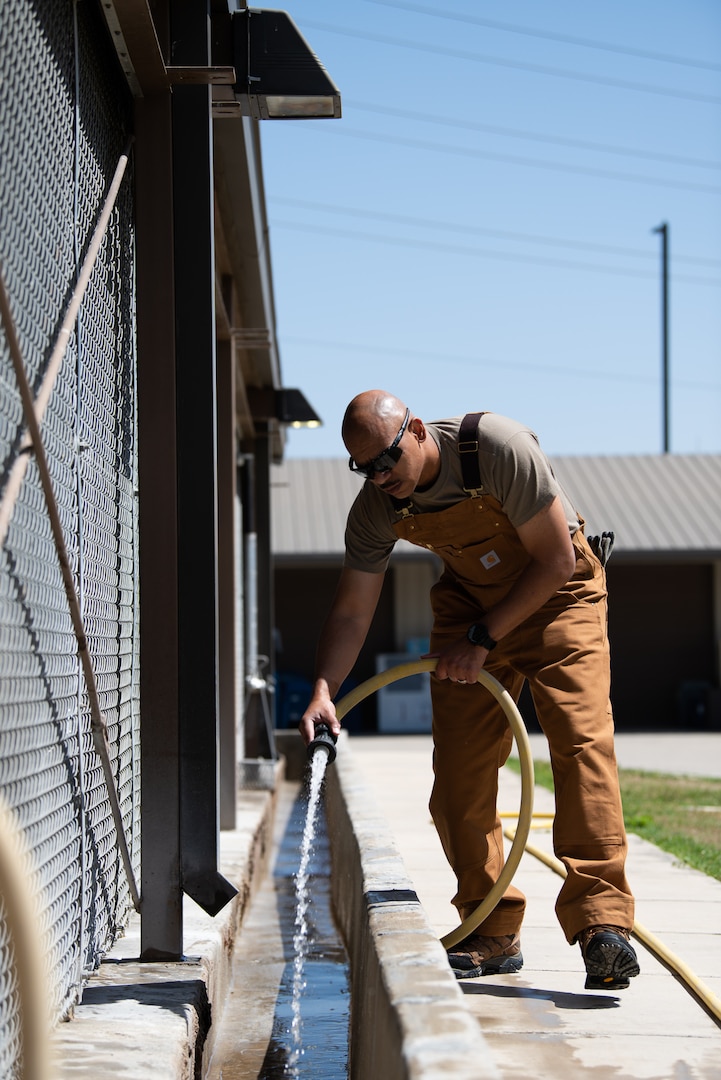 CMSgt Gravely cleans the military working dog kennels at JBSA-Lackland