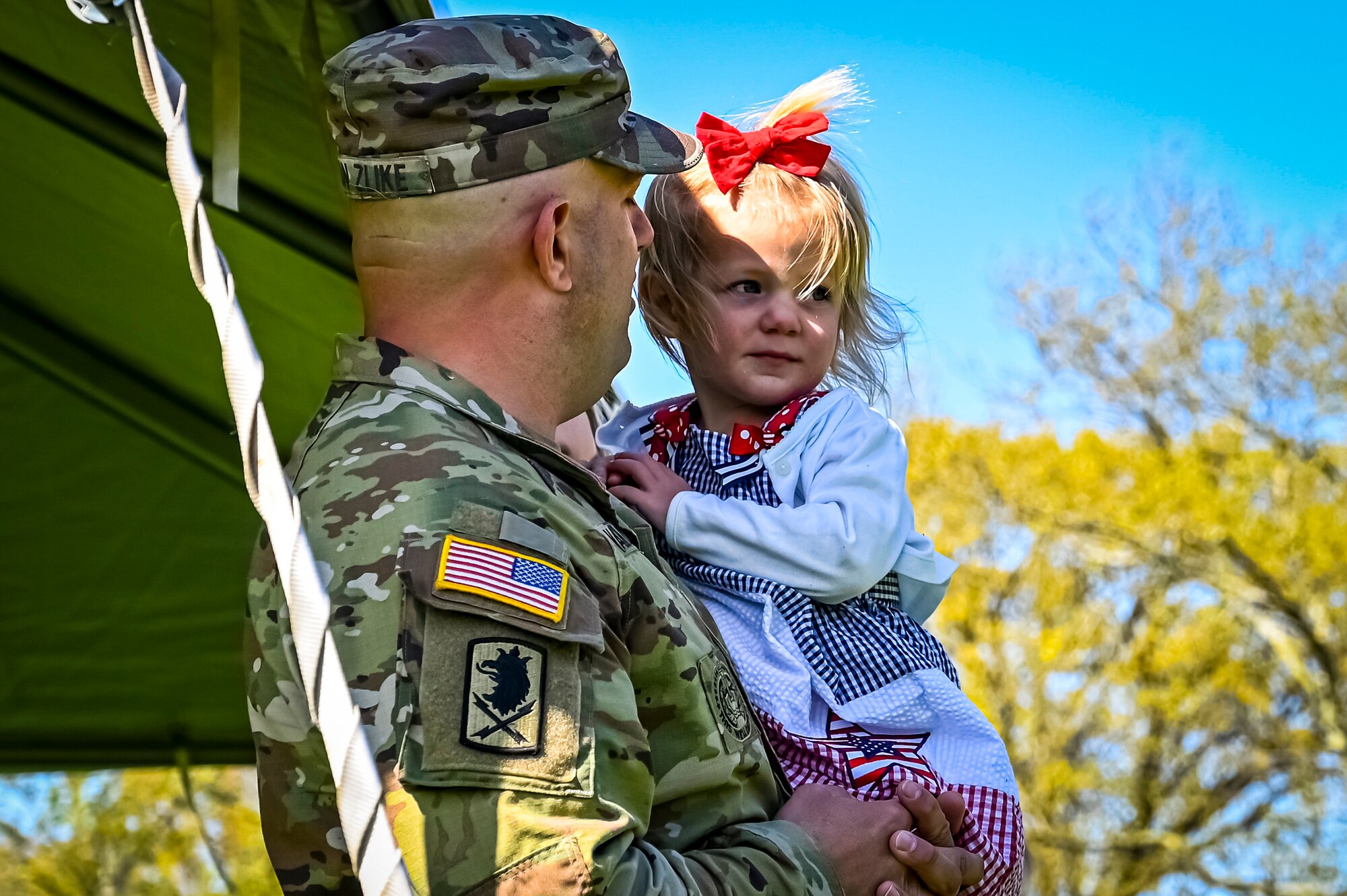 U.S. Army Command Sgt. Maj. James Van Zlike Army Support Activity Fort Fix, command sergeant major, holds his daughter during a change of responsibility on April 29, 2022, at Joint Base McGuire-Dix-Lakehurst, N.J. The ceremonial event was held to symbolize the transition of authority from Command Sgt. Maj. Tamara Edwards to Command Sgt. Maj. James Van Zlike. A change of responsibility ceremony is a traditional event meant to reinforce noncommissioned officer authority in the U.S. Army and highlights their support to the chain of command.