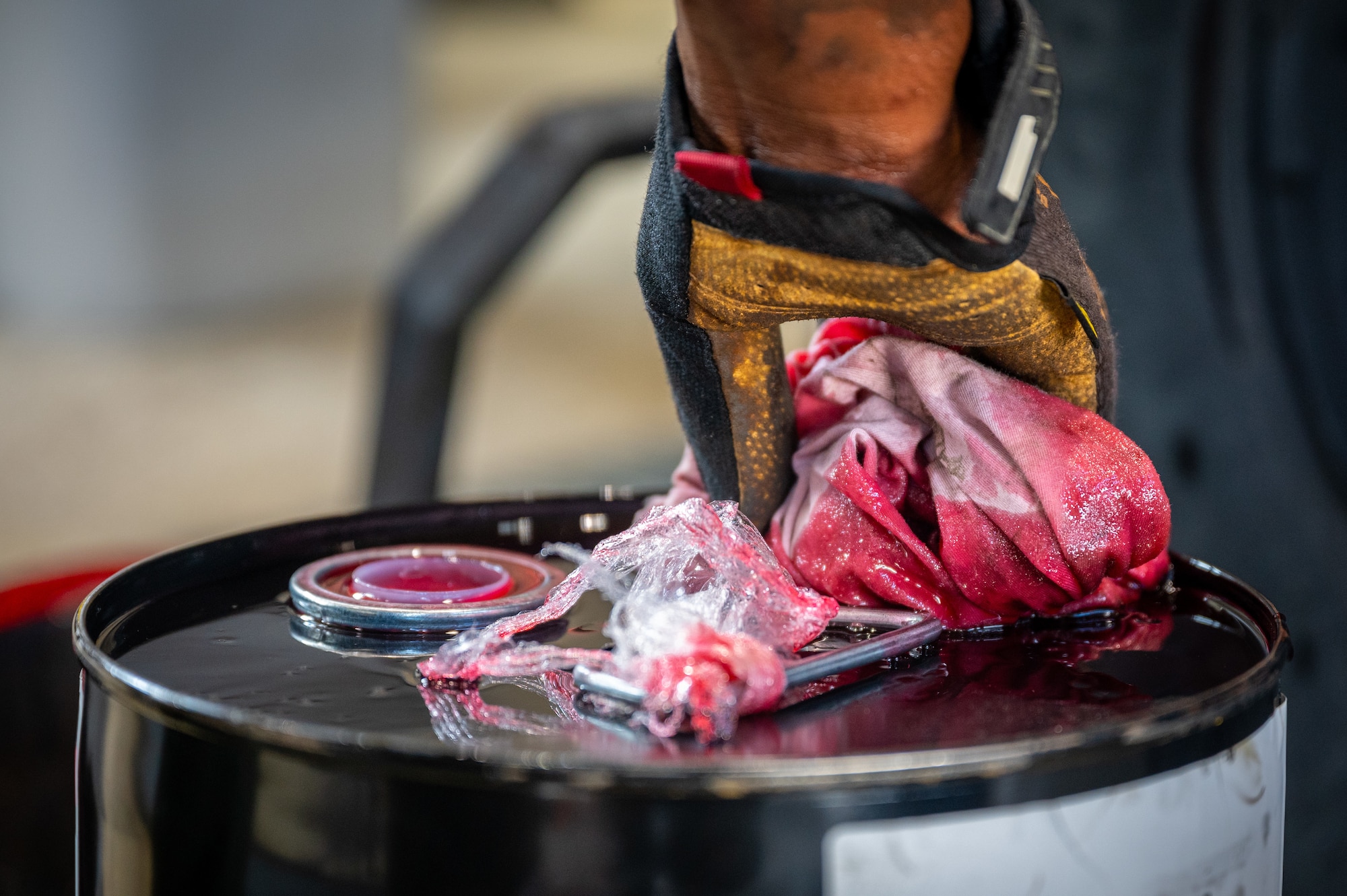 U.S. Army Specialist Darius Sims, 35th Air Defense Artillery Brigade all-wheel mechanic, closes up a barrel of powering steering fluid after working on a high mobility multipurpose wheeled vehicle (HMMWV) at Osan Air Base, Republic of Korea, April 29, 2022.