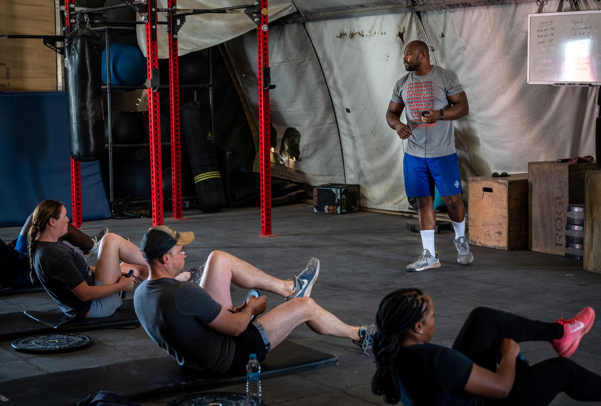 Billy Miles, Legends Fitness Center manager, coaches a core strengthening class at an undisclosed location in Southwest Asia, April 24, 2022. Miles offers personal training and teaches various lifting and core strengthening classes each week. “I take great pride in listening to the patrons and acquiring specific equipment or offering fitness classes to help them meet their goals,” said Miles. (U.S. Air Force photo by Master Sgt. Christopher Parr)