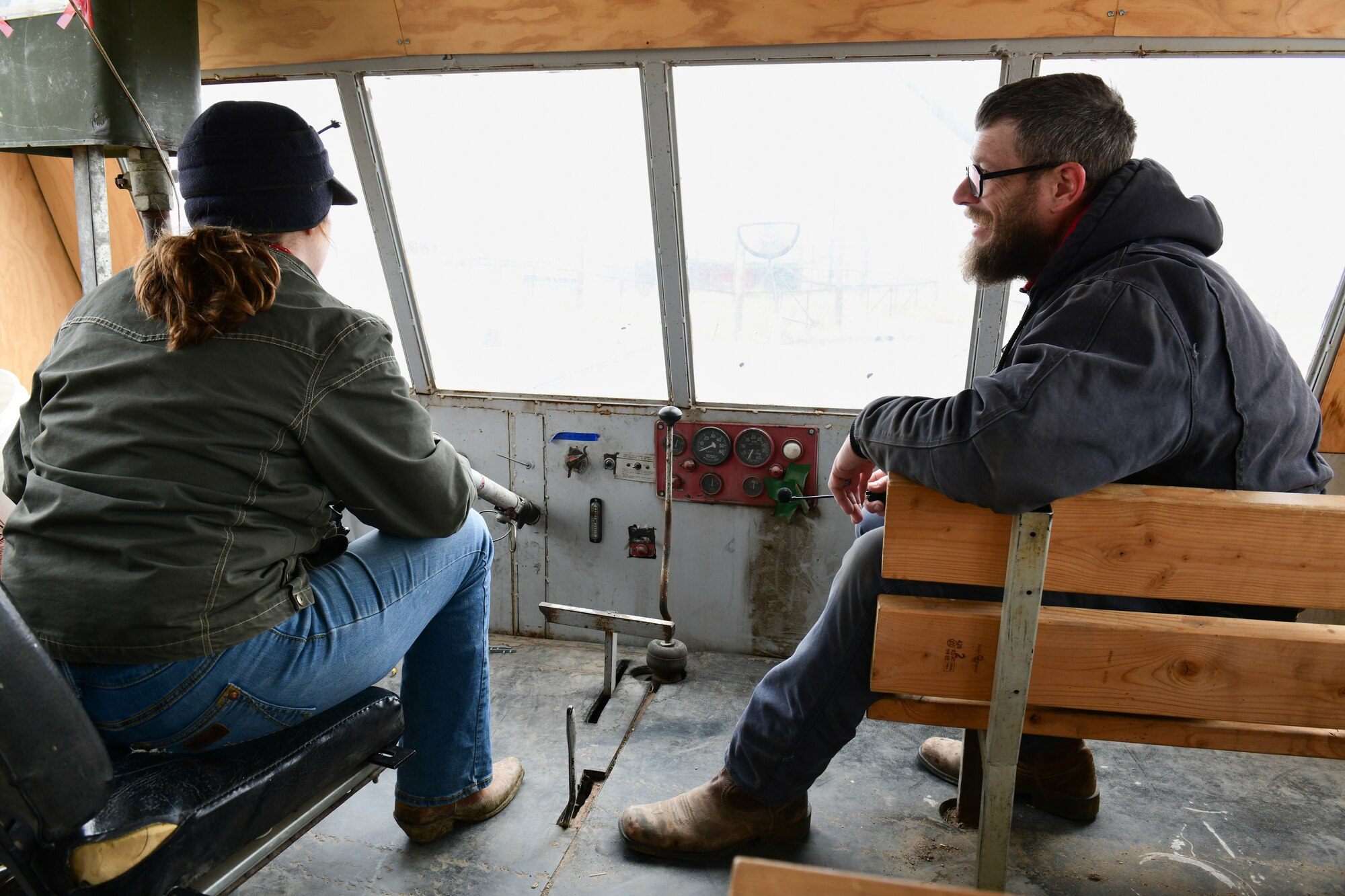 two people sit on benchs.