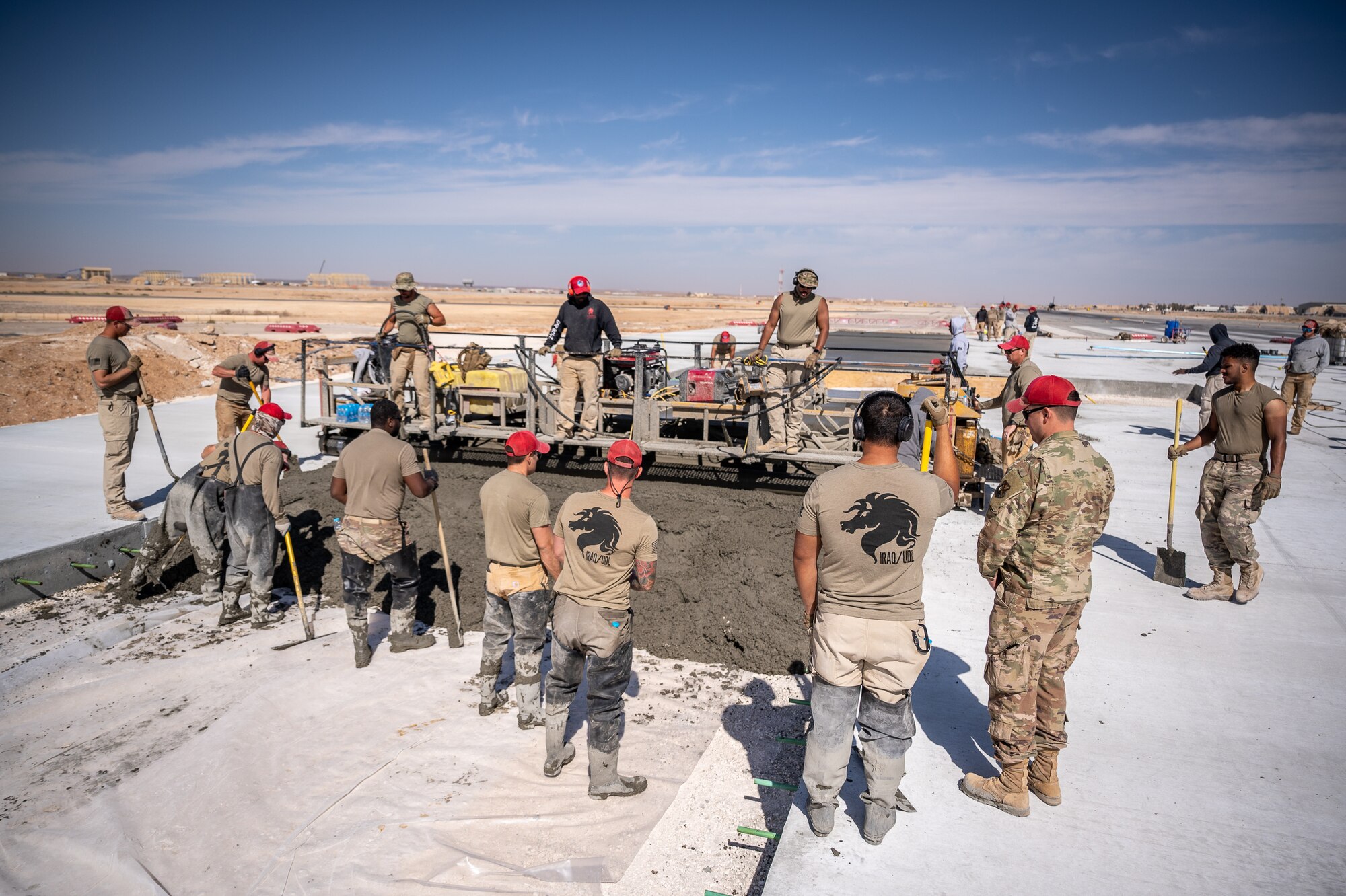 1st Expeditionary Civil Engineer Group Airmen pour more than 12,000 cubic meters of concrete for a runway overrun repair project at an undisclosed location in Southwest Asia, April 14, 2022. (U.S. Air Force photo by Master Sgt. Christopher Parr)