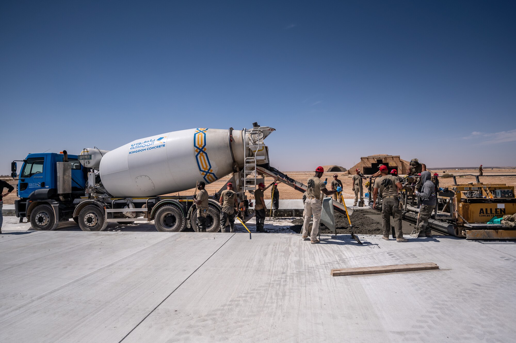1st Expeditionary Civil Engineer Group Airmen pour more than 12,000 cubic meters of concrete for a runway overrun repair project at an undisclosed location in Southwest Asia, April 14, 2022 (U.S. Air Force photo by Master Sgt. Christopher Parr)