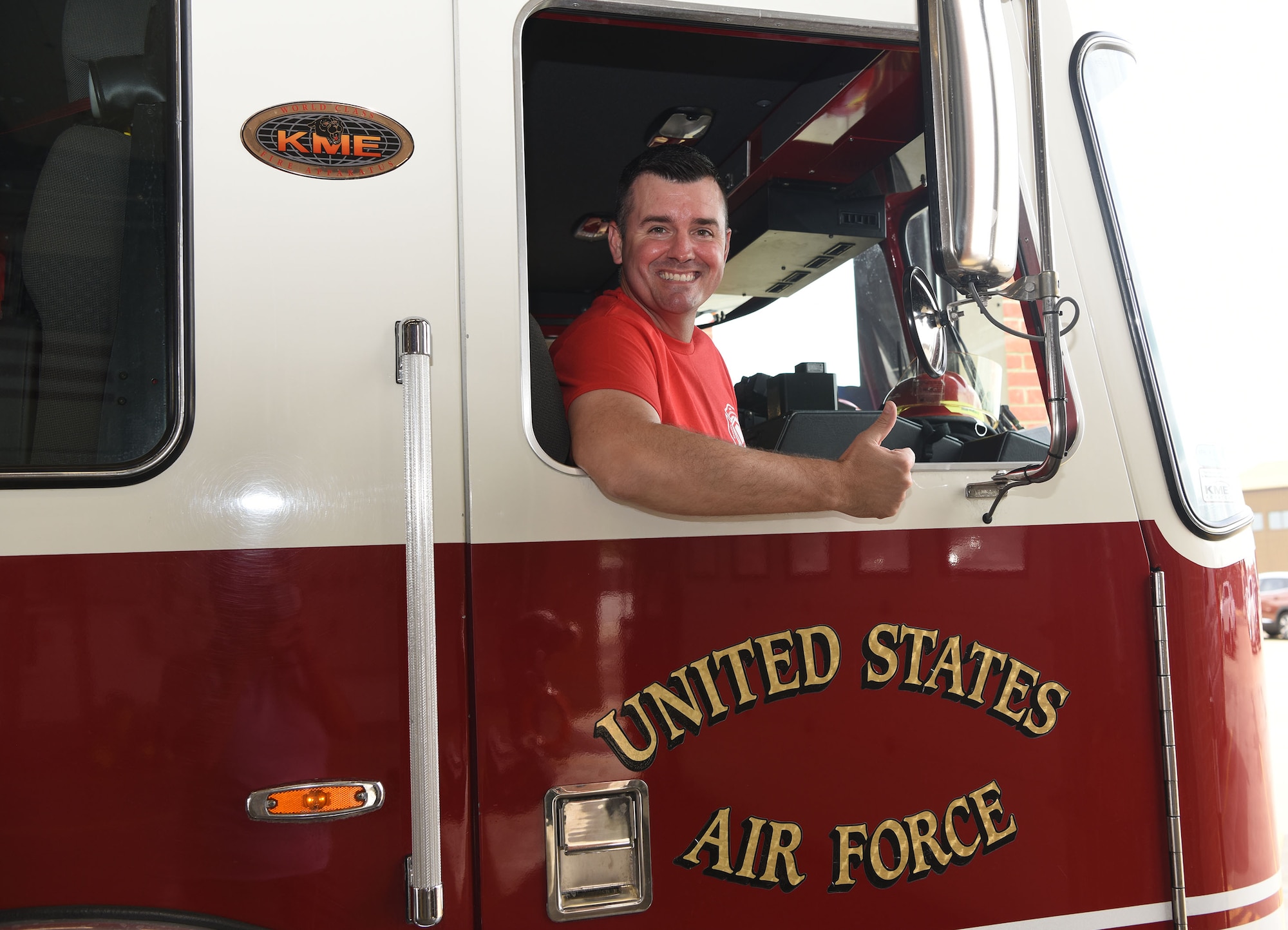 U.S. Air Force Col. Gene Jacobus, 100th Air Refueling Wing commander, shows his excitement as he prepares to head out to the live-fire training area for a hands-on experience with the 100th Civil Engineer Squadron Fire Department at Royal Air Force Mildenhall, England, July 28, 2022. The commander spent time learning what goes on behind the scenes to protect the base and mission every day. (U.S. Air Force photo by Karen Abeyasekere)