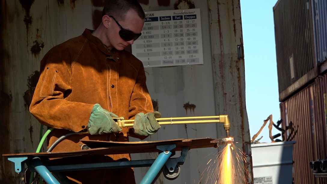 Man cuts metal with a torch