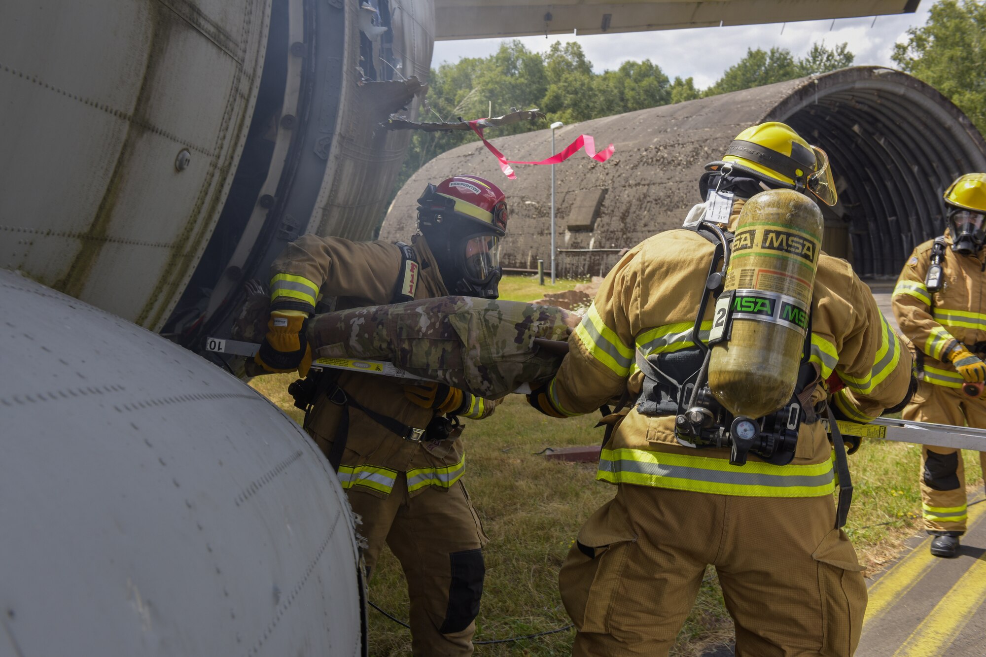 Firemen rescue a simulated casualty during a base exercise