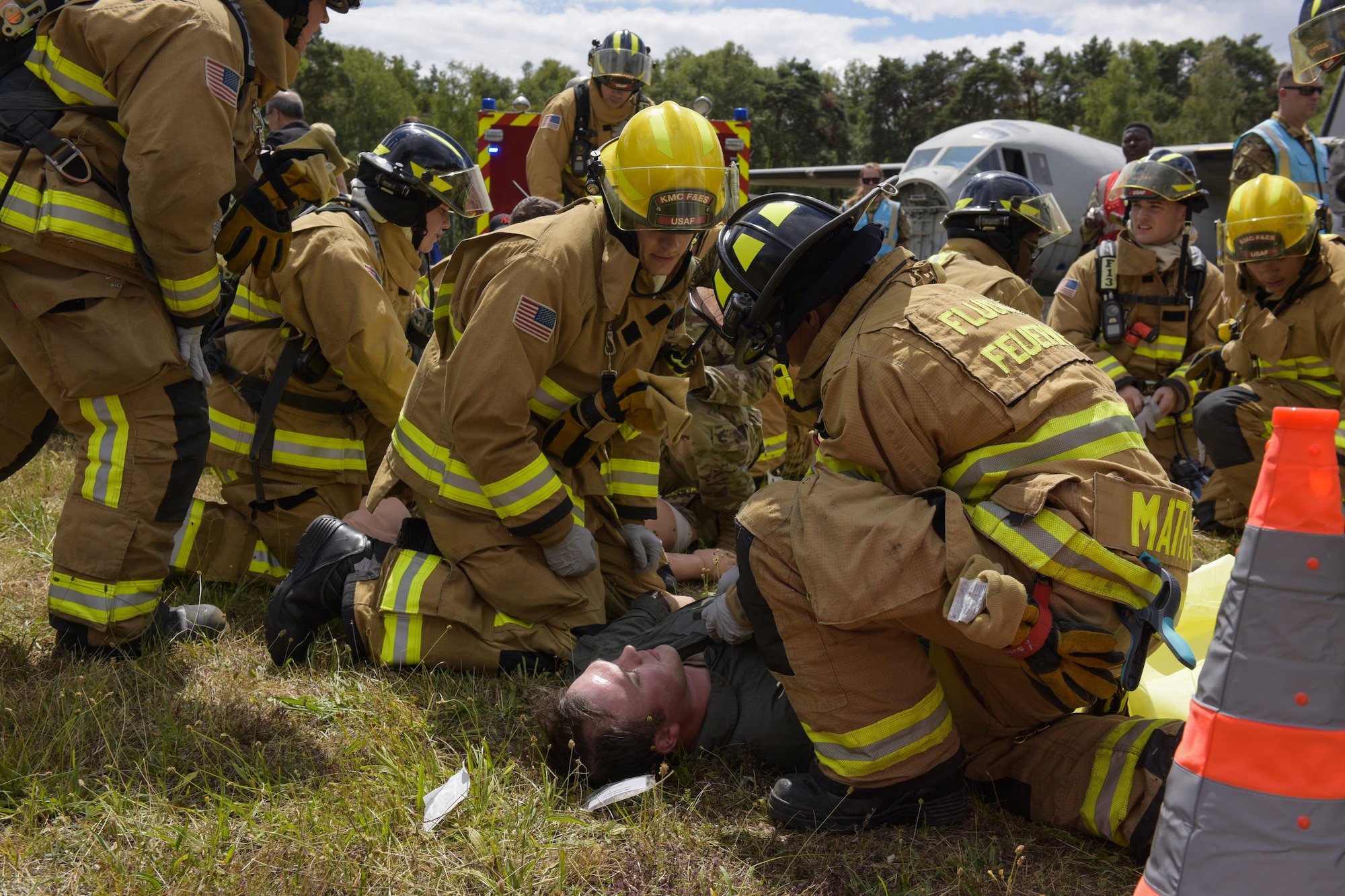 Firemen provide first aid to simulated injured personnel