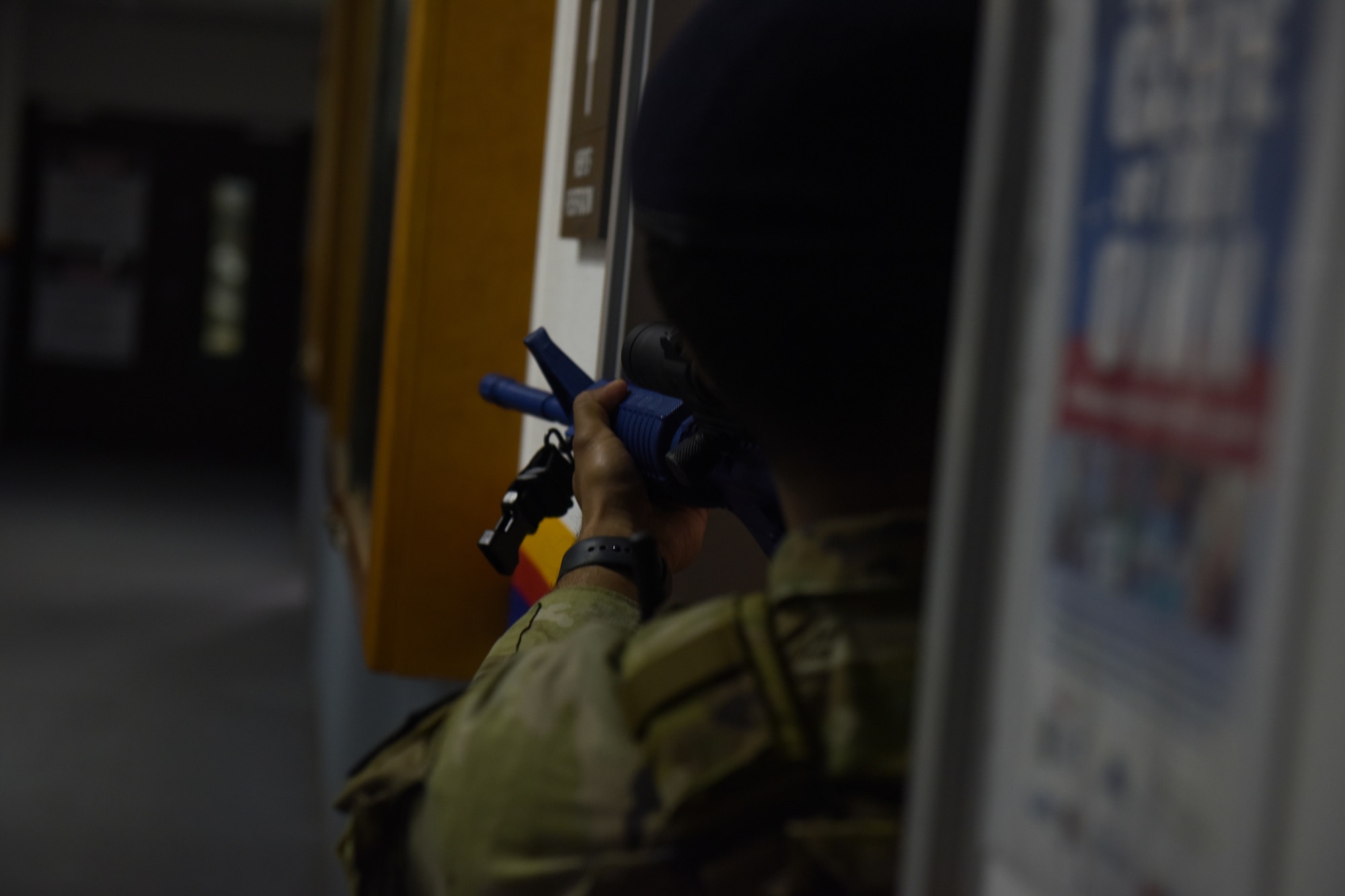 Man uses rubber firearm to clear a hallway during an active shooter simulation