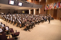 U.S. Marine Corps Col. Robert G. McCarthy, branch head of Marine Manpower Enlisted Assignments (MMEA), Marine Corps Manpower and Reserve Affairs, addresses Marines with Fleet Marine Force, Atlantic (FMFLANT), Marine Forces Command (MARFORCOM), Marine Forces Northern Command (MARFOR NORTHCOM), during an all hands professional military education assembly at Naval Support Activity Hampton Roads, Virginia, July 28, 2022. Leaders from MMEA visited FMFLANT, MARFORCOM, MARFOR NORTHCOM to present information and provide guidance to enlisted Marines on career advancement, special duty assignments and re-enlistment incentives. MMEA ensures Marines who are eligible for reenlistment in Fiscal Year 2023 are able to make informed decisions about their careers, assignment options, and potential for future service. (U.S. Marine Corps Photo by Casey Price)
