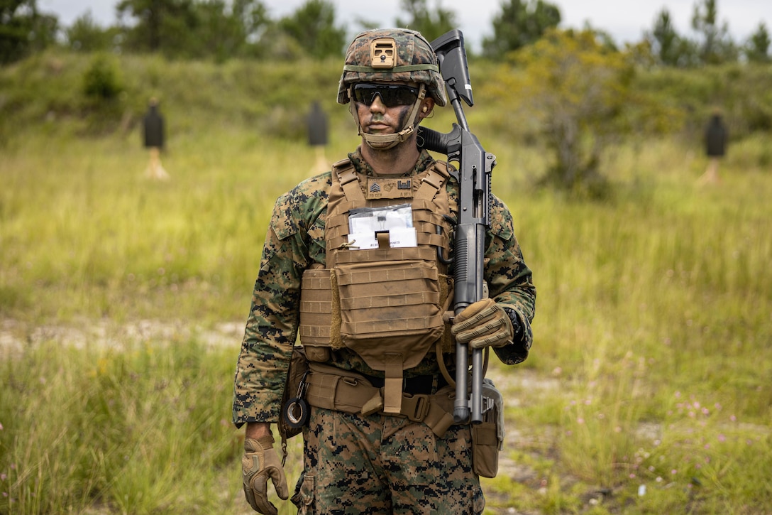 U.S. Marine Corps Sgt. Dylan Tyler, a combat engineer with 8th Engineer Support Battalion, Combat Logistics Regiment 27, 2nd Marine Logistics Group, holds an M1014 shotgun before a ballistics breaching range during Summer Pioneer 22 on Camp Lejeune, July 23, 2022. Summer Pioneer is a naval engineering exercise demonstrating integrated U.S. Marine Corps and U.S. Navy formations to establish and sustain expeditionary advanced bases and maritime domain awareness. (U.S. photo by Cpl. Scott Jenkins)
