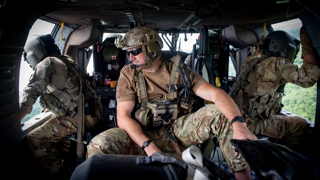 Airmen from the Kentucky Air National Guard’s 123rd Special Tactics Squadron search for flood victims from a helicopter in Eastern Kentucky on July 30, 2022. In response to devastating flooding, the unit coordinated 29 rotary-wing relief missions, rescued 19 people and two dogs, and recovered four bodies. Their command-and-control efforts also facilitated the assistance or recovery of 40 people. (U.S. Air National Guard photo by Staff Sgt. Clayton Wear)