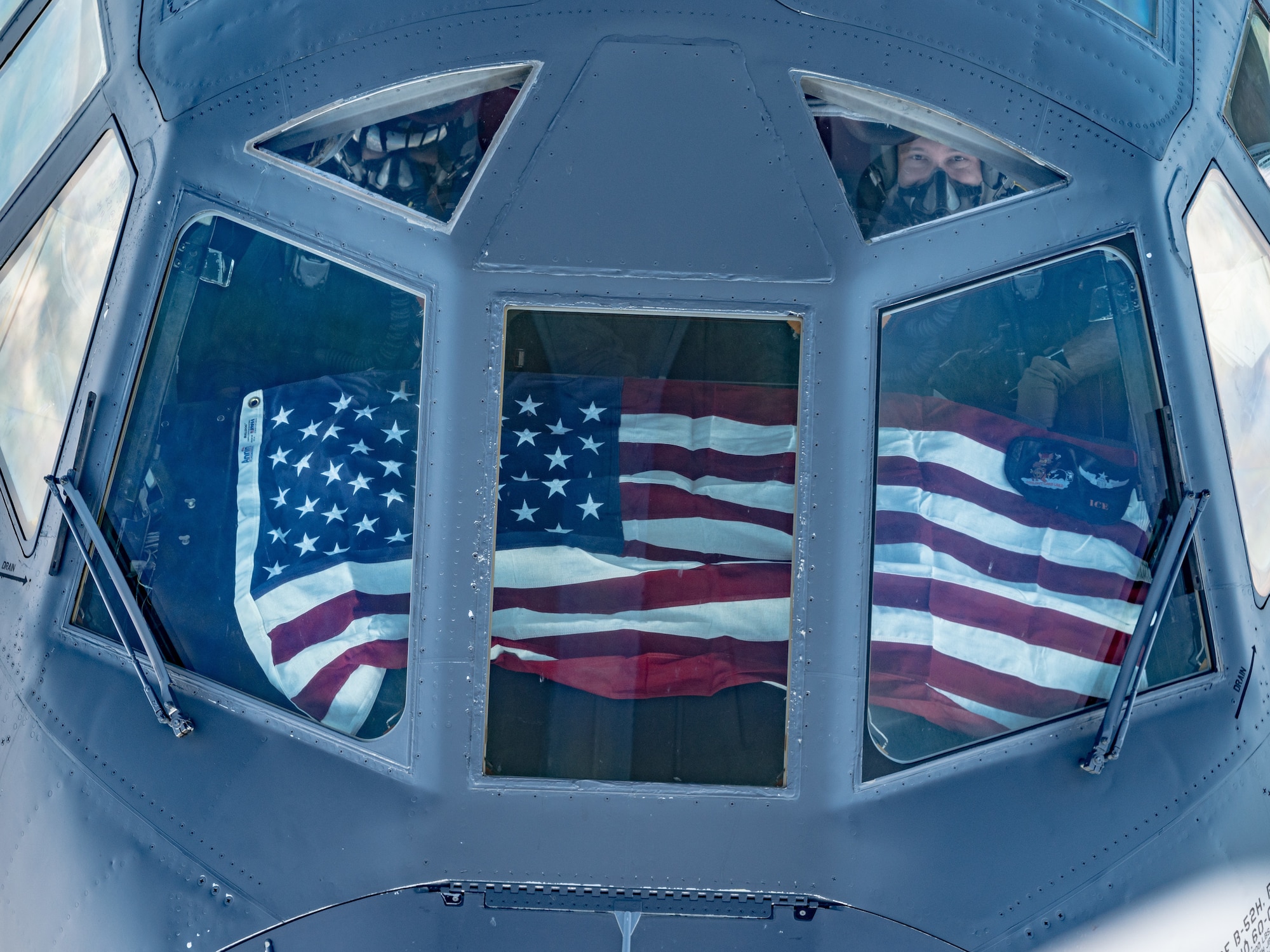 Photo of a B-52 in flight carrying U.S. Flag