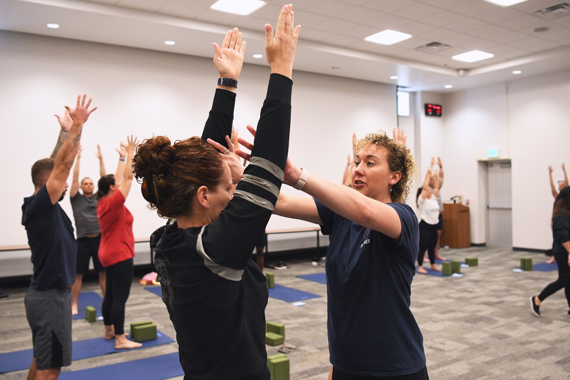 Olivia Mead, a yoga instructor, teaches a yoga class July 18, 2022 at the 178th Wing in Springfield, Ohio. The training is a part of a pilot program called Yoga Shield, which aims to teach Airmen to reduce stress and to build mental and physical resiliency through yoga. (U.S. Air National Guard photo by Shane Hughes)