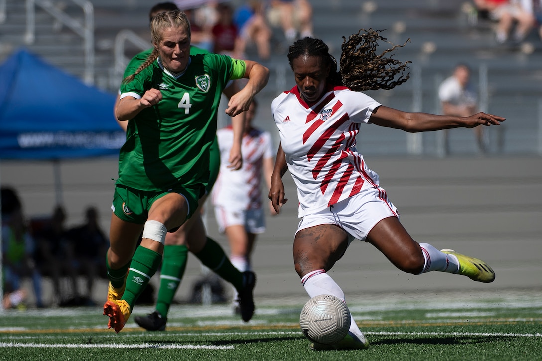 Army 1st Lt. Haley Roberson, right, kicks a ball during the Americans' 5-0 win over Ireland on July 19, 2020. The United States finished fourth in the 2022 World Military Women's Football Championship in Spokane, Wash.