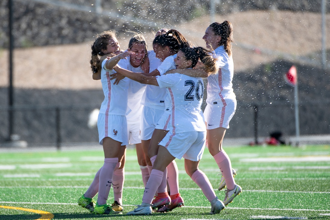 French-American soccer player Rachel Corboz, left, celebrates one of her two goals with her French military teammates during France's 2-1 win over Cameroon in the 2022 Women's Military Football World Cup gold medal match.