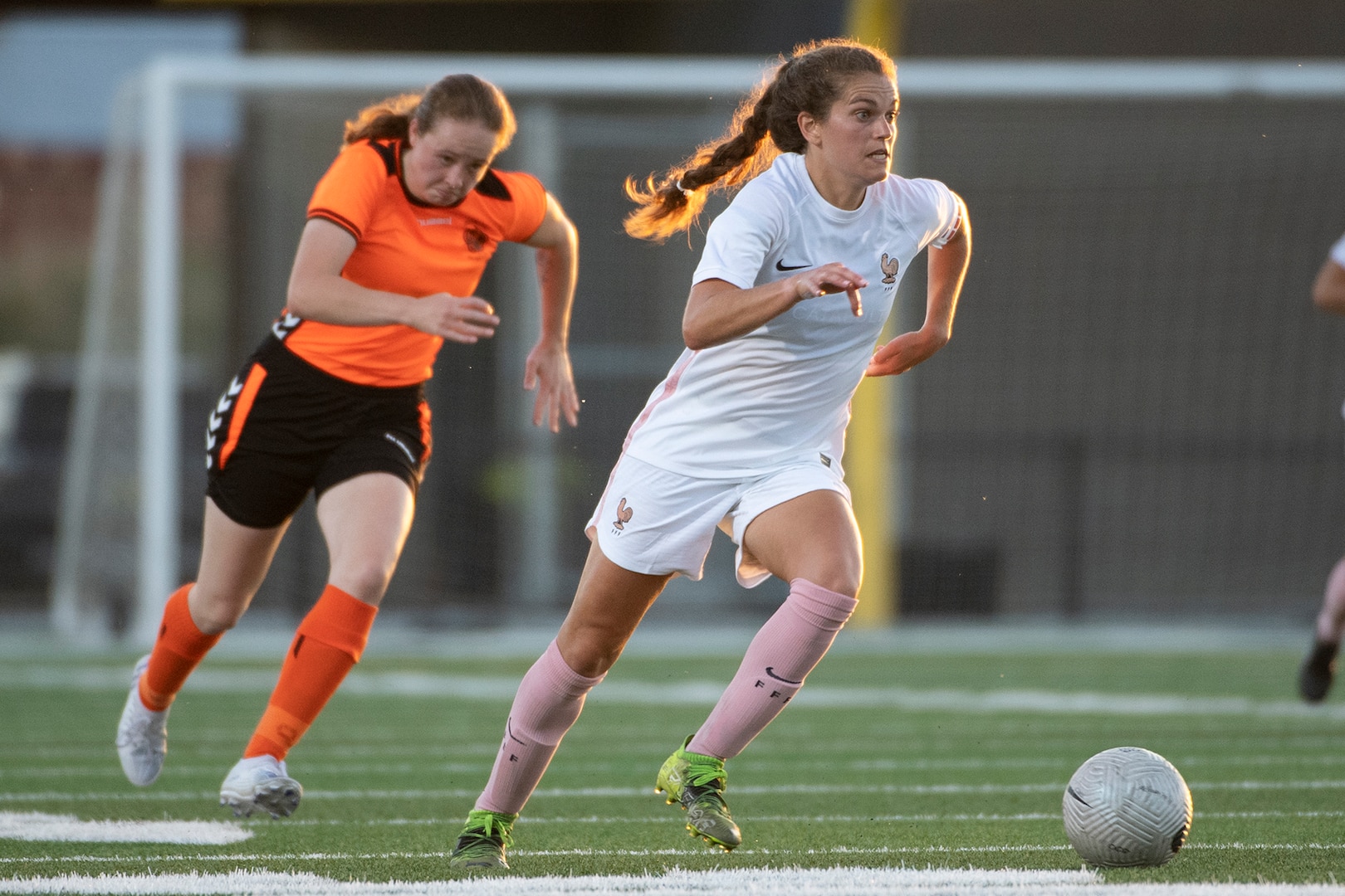 French center midfielder Rachel Corboz, right, pushes the ball upfield during France's 8-0 victory over the Netherlands in the 2022 World Military Women's Football Championship on July 12, 2022.