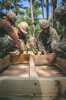 U.S. Marines with 8th Engineer Support Battalion, Combat Logistics Regiment 27, 2nd Marine Logistics Group, and U.S. Navy Seabees with Naval Mobile Construction Battalion 1 build a SWA hut during Summer Pioneer 2022 at Camp Lejeune, North Carolina, July 19, 2022. Summer Pioneer 2022 is a naval engineering exercise demonstrating integrated U.S. Marine Corps and U.S. Navy formations to establish and sustain Expeditionary Advanced Bases (EAB) and Maritime Domain Awareness. (U.S. Marine Corps photo by Lance Cpl. Meshaq Hylton)