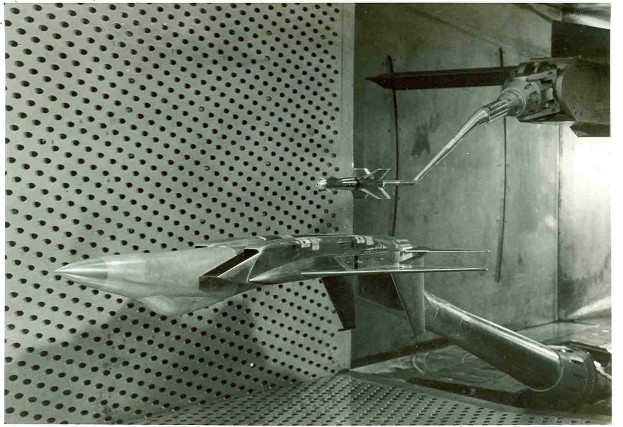 Data for flow field grid surveys are obtained in the early 1980s in the 4-foot transonic wind tunnel at Arnold Air Force Base, Tennessee, headquarters of Arnold Engineering Development Complex, using 5% scale models of the F-15 Eagle and Guided Bomb Unit 15 Cruciform Wing Weapon store, which is mounted on the tunnel’s Captive Trajectory System. The Air Force recently celebrated the 50th anniversary of the F-15’s deployment. Models of the aircraft, engines and other F-15 components have frequently been tested by AEDC over the past 50 years. (U.S. Air Force photo)
