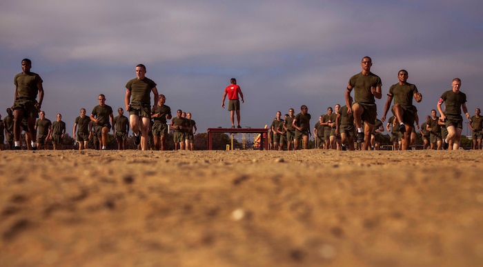 U.S. Marine Corps Gunnery Sgt. Jashwa Rivera, a Chief Drill Instructor with Bravo Company, 1st Recruit Training Battalion, leads warm ups during a physical training session at Marine Corps Recruit Depot San Diego, July 26, 2022.