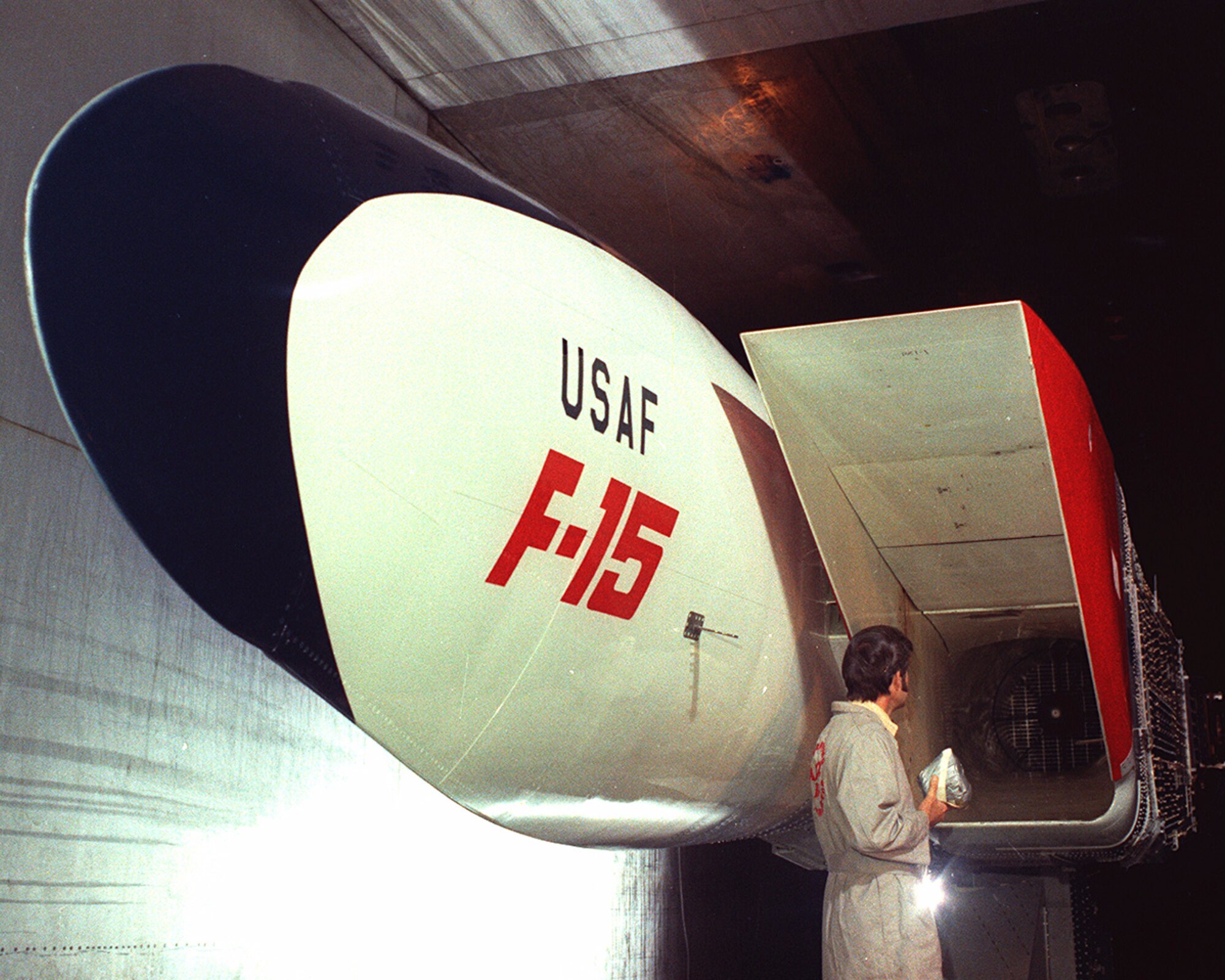 The compatibility of the Pratt & Whitney F100 engine to the variable geometry inlet of the F-15 Eagle is evaluated in 1972 in the 16-foot supersonic wind tunnel at Arnold Air Force Base, Tennessee, headquarters of Arnold Engineering Development Complex. Since the test section was not large enough to accommodate a full-sized nose section, a special fuselage segment designed to produce inlet airflow conditions the F-15 would encounter in flight was installed in the wind tunnel. The test hardware was cycled through a wide range of altitude and speed conditions. The Air Force recently celebrated the 50th anniversary of the F-15’s deployment. Models of the aircraft, engines and other F-15 components have frequently been tested by AEDC over the past 50 years. (U.S. Air Force photo)