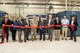 Photo of Representatives from the U.S. Air Force, L3Harris Technologies, and Tobyhanna Army Depot cutting a red ribbon.