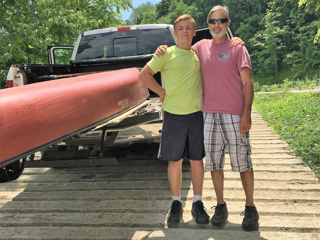 Safety Officer John Schnebelen Sr. and his grandson Zander Poulton pose together June 9, 2018, after completing leg 22 of a team building voyage of the Cumberland River. Employees and family members cruised their way in canoes, kayaks, and boats downriver over 650 of 694 miles of the waterway. Schnebelen wrote a poem about the magnificence of the Cumberland River voyage in the trip logbook. (USACE Photo)