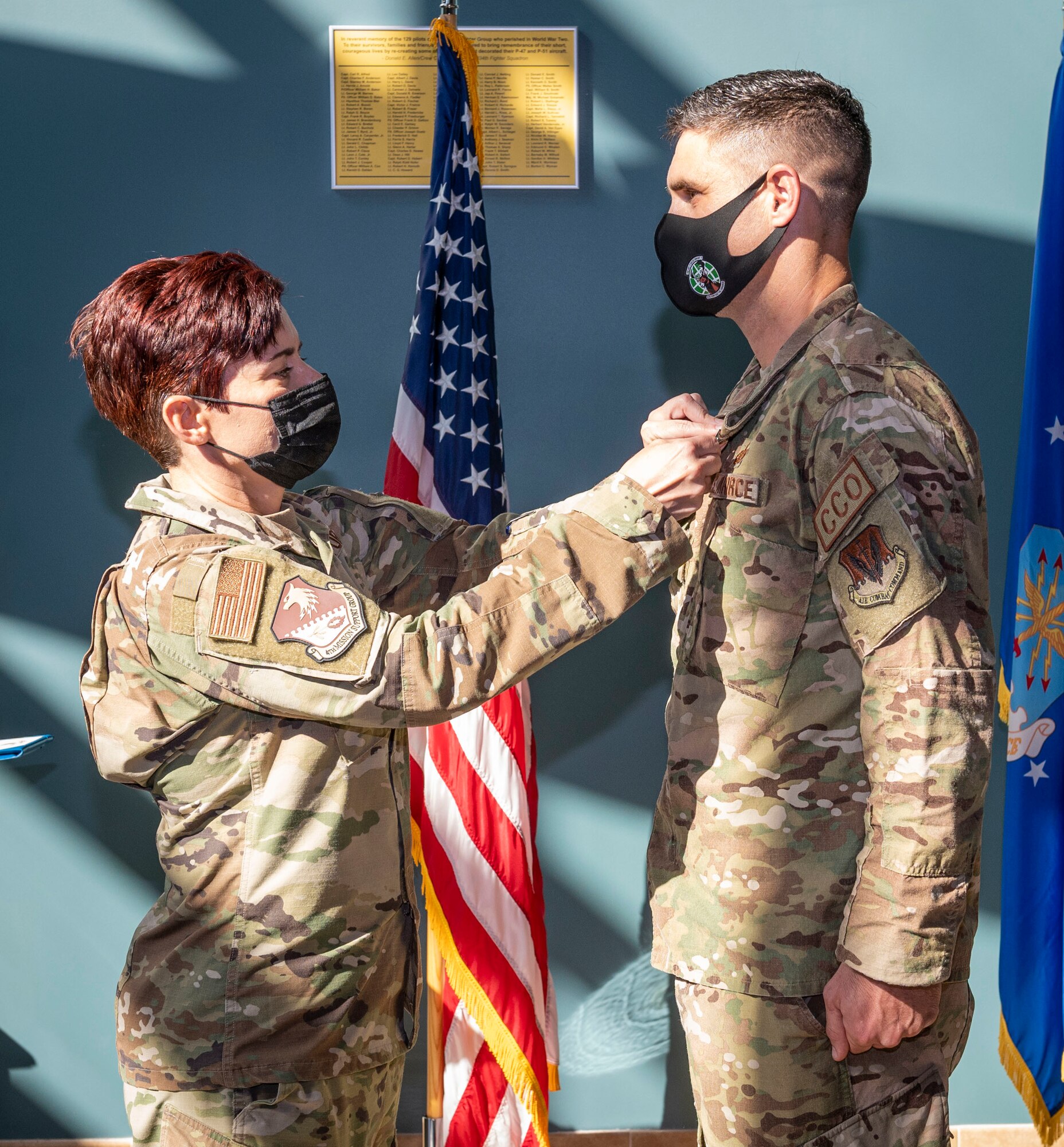 Col. Tammy McElhaney, left, 4th Mission Support Group commander, pins the Legion of Merit medal on Lt. Col. Michael Hawkins, outgoing 4th Contracting Squadron commander, during a change of command ceremony at Seymour Johnson Air Force Base, North Carolina, July 29, 2022. During his command, Hawkins provided contract support for over $3 billion in assets and ensured execution of an annual operations and maintenance budget of $90 million. (U.S. Air Force photo by Airman 1st Class Sabrina Fuller)