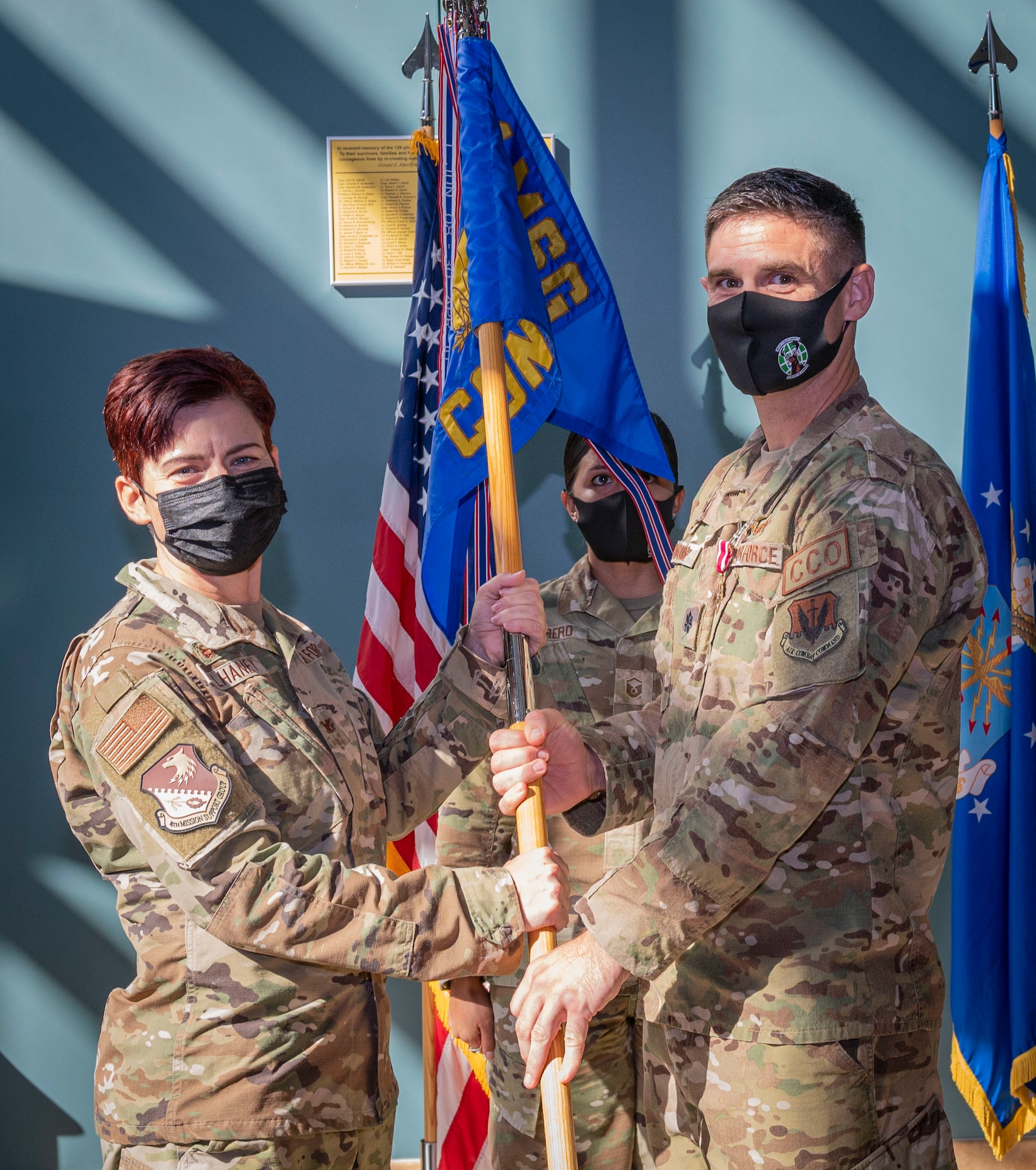 Lt. Col. Michael Hawkins, outgoing 4th Contracting Squadron commander, relinquishes the guidon to Col. Tammy McElhaney, 4th Mission Support Group commander, during a change of command ceremony at Seymour Johnson Air Force Base, North Carolina, July 29, 2022. Hawkins was responsible for providing infrastructure and base operations contracting support to the 4th Fighter Wing and the 916th Air Refueling Wing. ( U.S. Air Force photo by Airman 1st Class Sabrina Fuller)