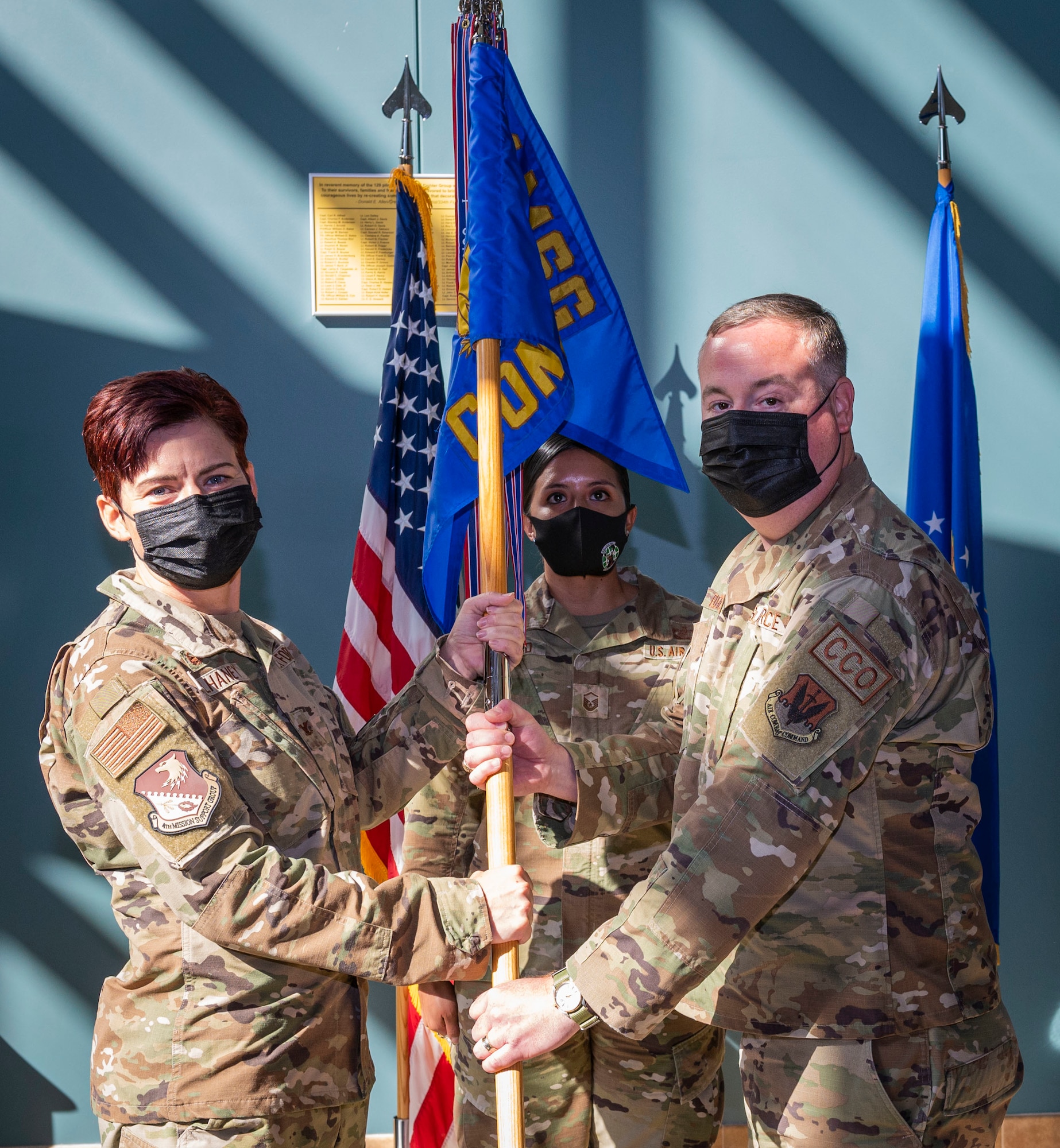 Col. Tammy McElhaney, 4th Mission Support Group commander, passes the guidon to Lt. Col. Steven Fletcher, incoming 4th Contracting Squadron commander, during a change of command ceremony at Seymour Johnson Air Force Base, North Carolina, July 29, 2022. Fletcher has served as a career contracting officer across four major commands. (U.S. Air Force photo by Airman 1st Class Sabrina Fuller)