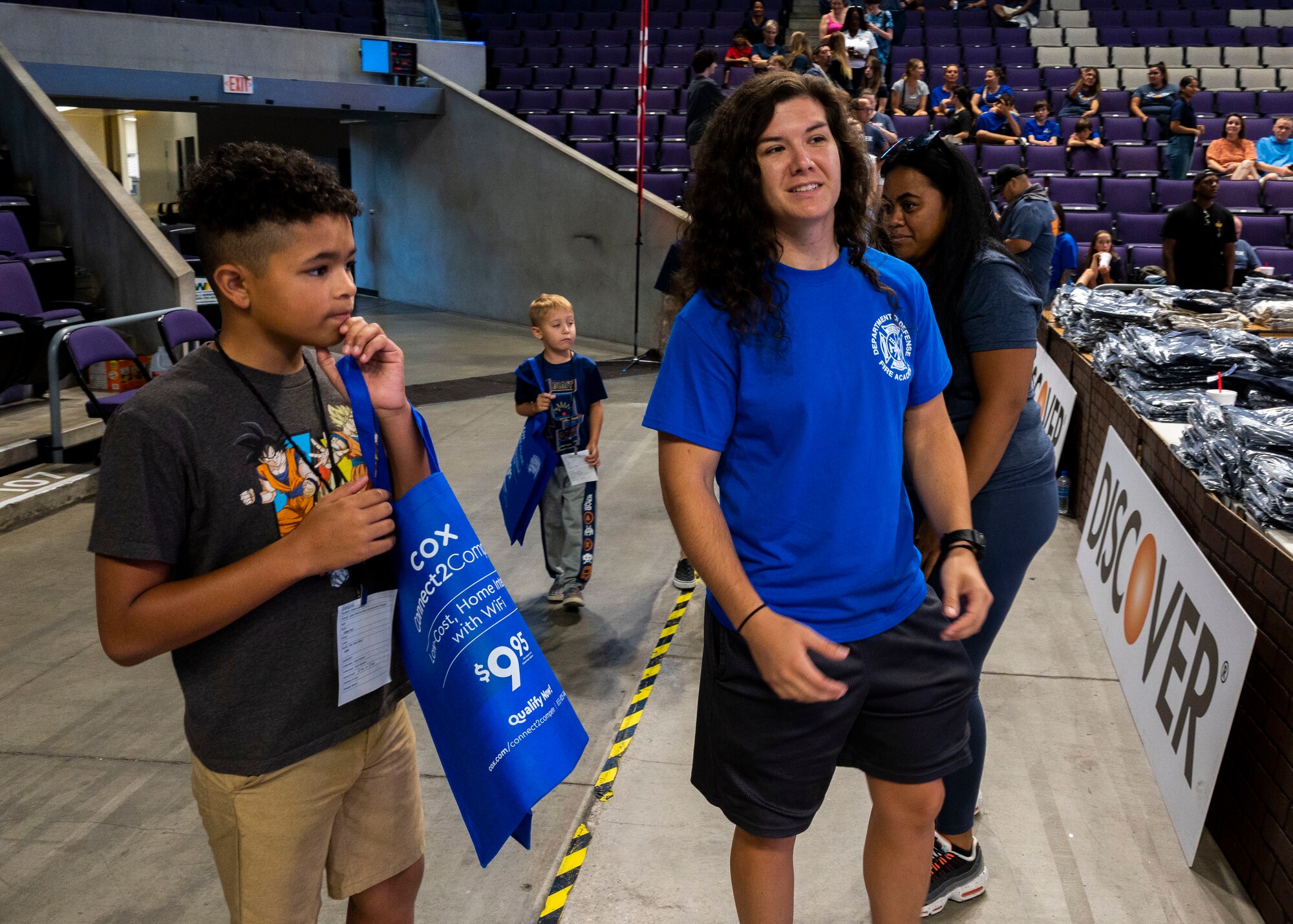 U.S. Air Force Airman 1st Class Rebekah Langley, 56th Civil Engineer Squadron fire protection, guides a student through the Back to School Bash event July 20, 2022, at Grand Canyon University, Phoenix, Arizona.