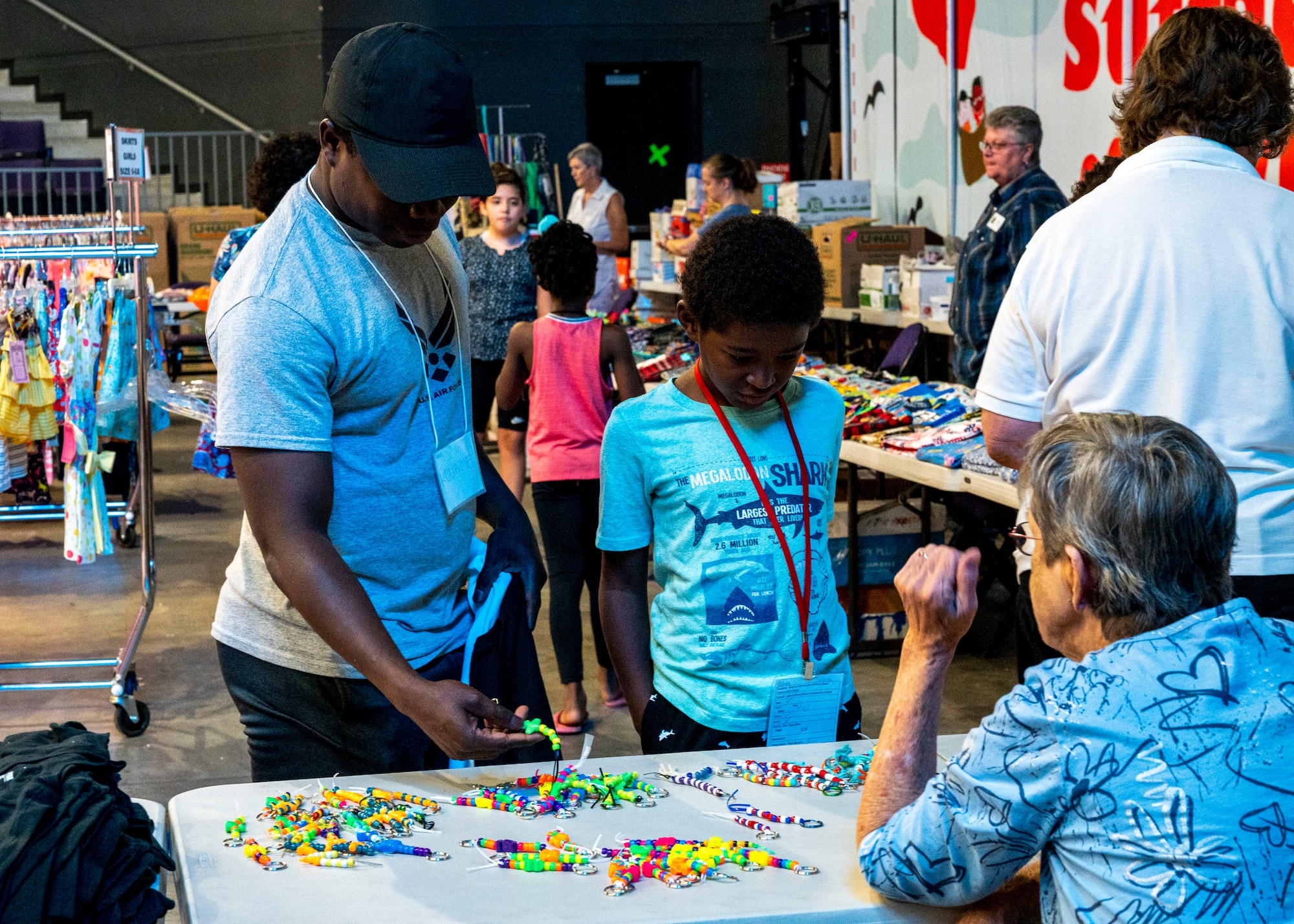 U.S. Air Force Airman 1st Class Kouame Koffi, 56th Logistics Readiness Squadron fleet management and analysis journeyman, helps a student pick out supplies and other items at the Back to School Bash event July 20, 2022, at Grand Canyon University, Phoenix, Arizona.
