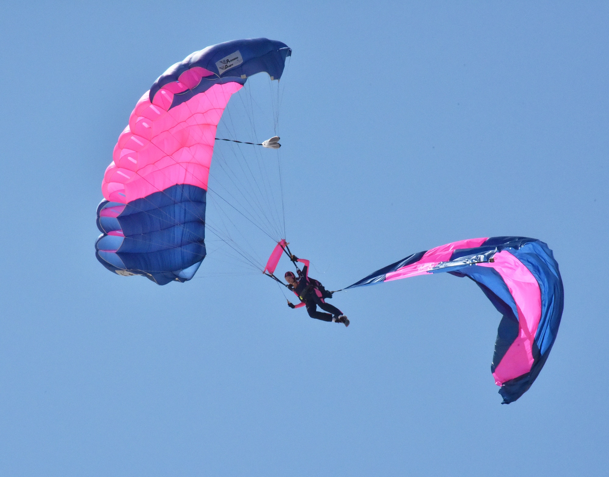 190330-N-KM072-006 KEY WEST, Fla. (March 30, 2019) A member of the all-women parachute team, the Misty Blues, prepares to land on the runway at Naval Air Station Key West during the 2019 Southernmost Air Spectacular air show. The two-day show attracted 20,000 spectators, and showcased the pride and professionalism of the U.S. Navy. Naval Air Station Key West is the state-of-the-art facility for combat fighter aircraft of all military services, provides world-class pierside support to U.S. and foreign naval vessels, and is the premier training center for surface and subsurface military operations. (U.S. Navy photo by Danette Baso Silvers)