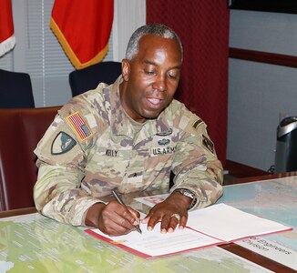 Brig. Gen. Jason Kelly signs the South Atlantic Coastal Study final report.