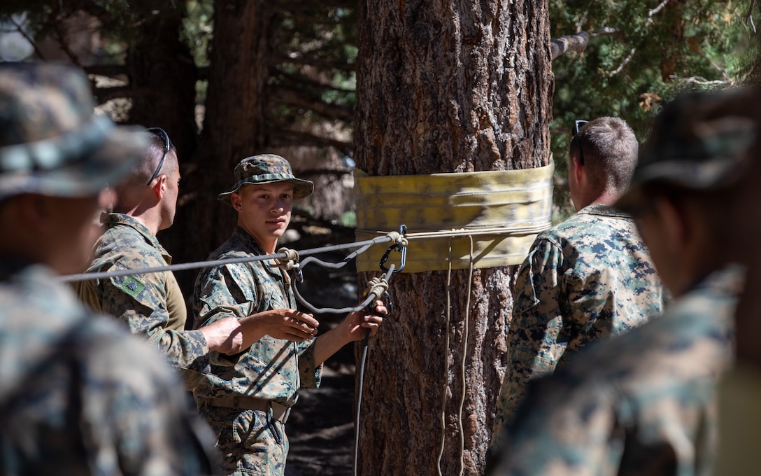 U.S. Marines with H&S Company, 1st Battalion, 24th Marine Regiment, 4th Marine Division, Marine Forces Reserve, are taught by instructors on rappelling across a ravine during a training class at Marine Corps Mountain Warfare Training Center, Bridgeport, Calif., July 22, 2022, for Mountain Training Exercise 4-22. MTX 4-22 allowed reserve Marines to participate in mountain warfare operations for realistic combat training in order to facilitate increased readiness for the Marine Forces Reserve. (U.S. Marine Corps photo by Cpl. Jonathan L. Gonzalez)
