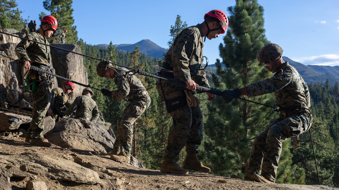 U.S. Marines with H&S Company, 1st Battalion, 24th Marine Regiment, 4th Marine Division, Marine Forces Reserve, rappel down a cliff during a training event at Marine Corps Mountain Warfare Training Center, Bridgeport, Calif., July 22, 2022, for Mountain Training Exercise 4-22. MTX 4-22 allowed reserve Marines to participate in mountain warfare operations for realistic combat training in order to facilitate increased readiness for the Marine Forces Reserve. (U.S. Marine Corps photo by Cpl. Jonathan L. Gonzalez)