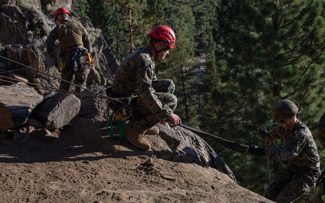 U.S. Marines with H&S Company, 1st Battalion, 24th Marine Regiment, 4th Marine Division, Marine Forces Reserve, rappel down a cliff during a training evolution at Marine Corps Mountain Warfare Training Center, Bridgeport, Calif., July 22, 2022, for Mountain Training Exercise 4-22. MTX 4-22 allowed reserve Marines to participate in mountain warfare operations for realistic combat training in order to facilitate increased readiness for the Marine Forces Reserve. (U.S. Marine Corps photo by Cpl. Jonathan L. Gonzalez)