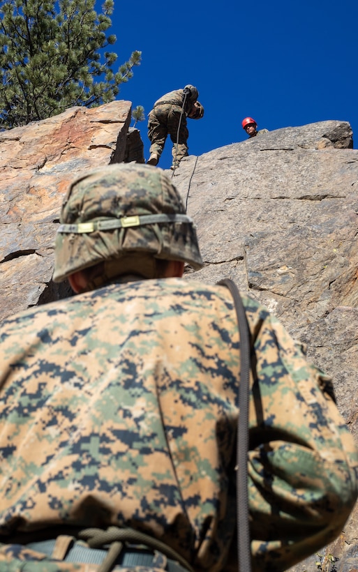 U.S. Marines with H&S Company, 1st Battalion, 24th Marine Regiment, 4th Marine Division, Marine Forces Reserve, rappel down a cliff during a training event at Marine Corps Mountain Warfare Training Center, Bridgeport, Calif., July 22, 2022, for Mountain Training Exercise 4-22. MTX 4-22 offers a unique training experience for reserve Marines to prepare and develop an understanding of traversing a mountainous environment as they maintain their readiness. (U.S. Marine Corps photo by Cpl. Jonathan L. Gonzalez)