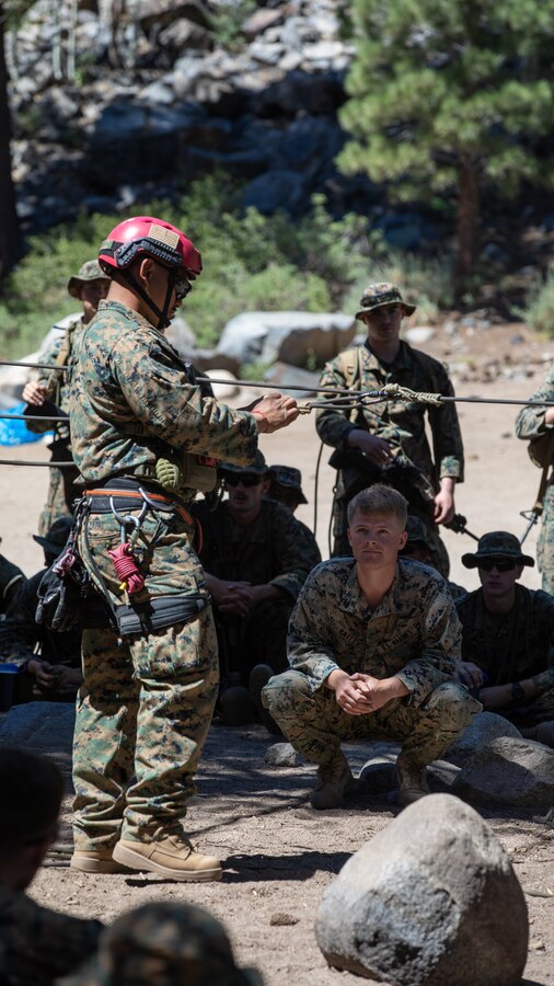 U.S. Marines with H&S Company, 1st Battalion, 24th Marine Regiment, 4th Marine Division, Marine Forces Reserve, are taught by instructors on rappelling across a ravine during a training class at Marine Corps Mountain Warfare Training Center, Bridgeport, Calif., July 22, 2022, for Mountain Training Exercise 4-22. MTX 4-22 allowed reserve Marines to participate in mountain warfare operations for realistic combat training in order to facilitate increased readiness for the Marine Forces Reserve. (U.S. Marine Corps photo by Cpl. Jonathan L. Gonzalez)