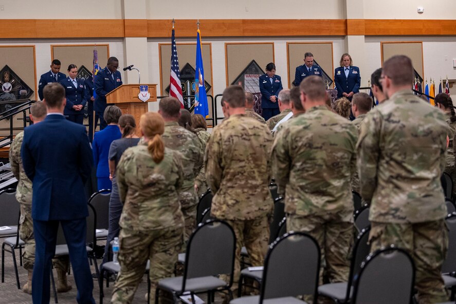 Capt. Dominic Smyth, 341st Missile Wing chaplain, leads Malmstrom personnel in prayer during a change of command ceremony July 28, 2022, at Malmstrom Air Force Base, Mont. Lt. Col. Darren Damiani relinquished command of the 341st Medical Operational Readiness Squadron to Lt. Col. Jennifer Harward. (U.S. Air Force photo by Airman 1st Class Elijah Van Zandt)