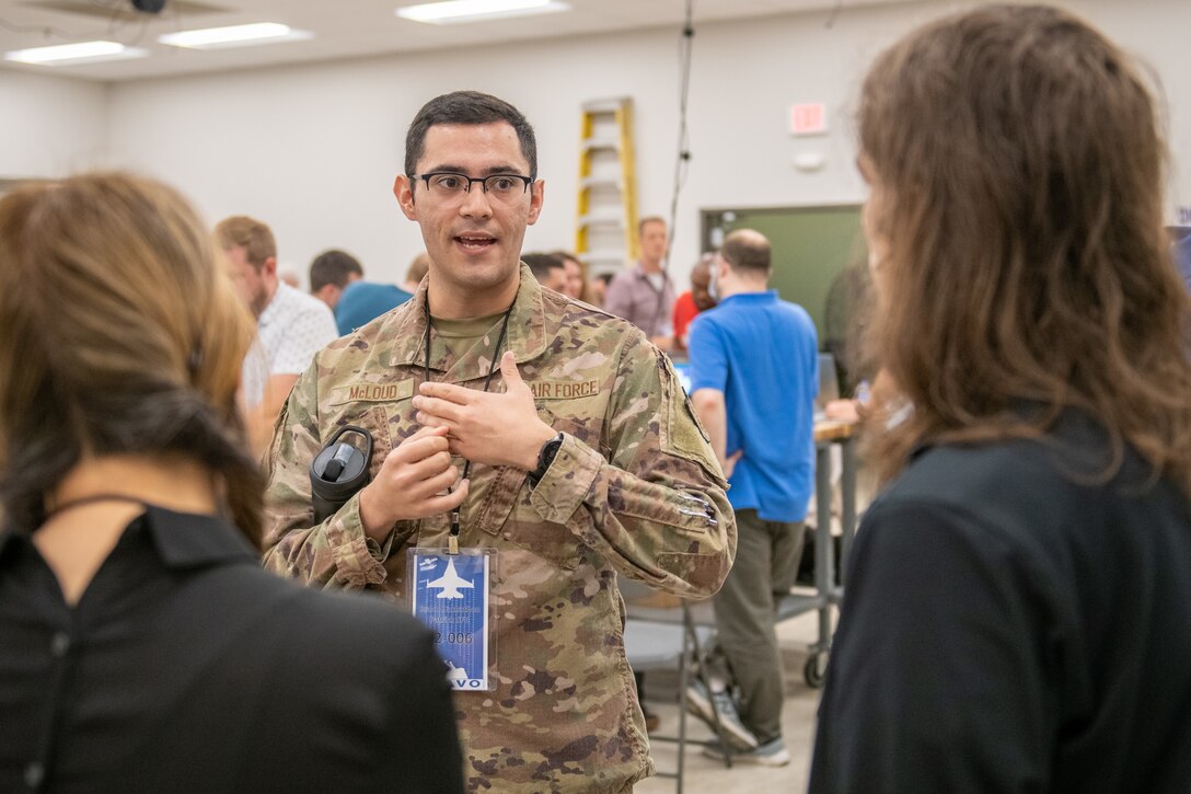 U.S. Air Force 1st Lt. Kennith McLoud, Air Force Operations Test and Evaluations Center operations research analyst, Eglin Air Force Base, Fla., meets with members of the BRAVO Hackathon July 18, 2022, at Patrick Space Force Base, Fla. The event brought engineers, scientists, and coders together from four countries to solve problems with the launch mission.   (U.S. Space Force photo by Josh Conti)