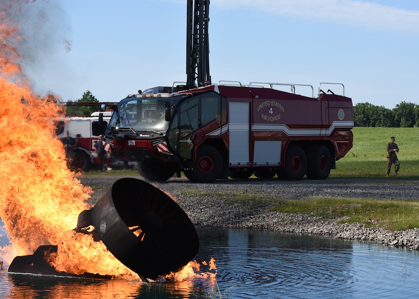 Cadets use a fire truck with a high-rise extension turret during a simulated aircraft fire at Joint Base Andrews, Md. July 30, 2022.