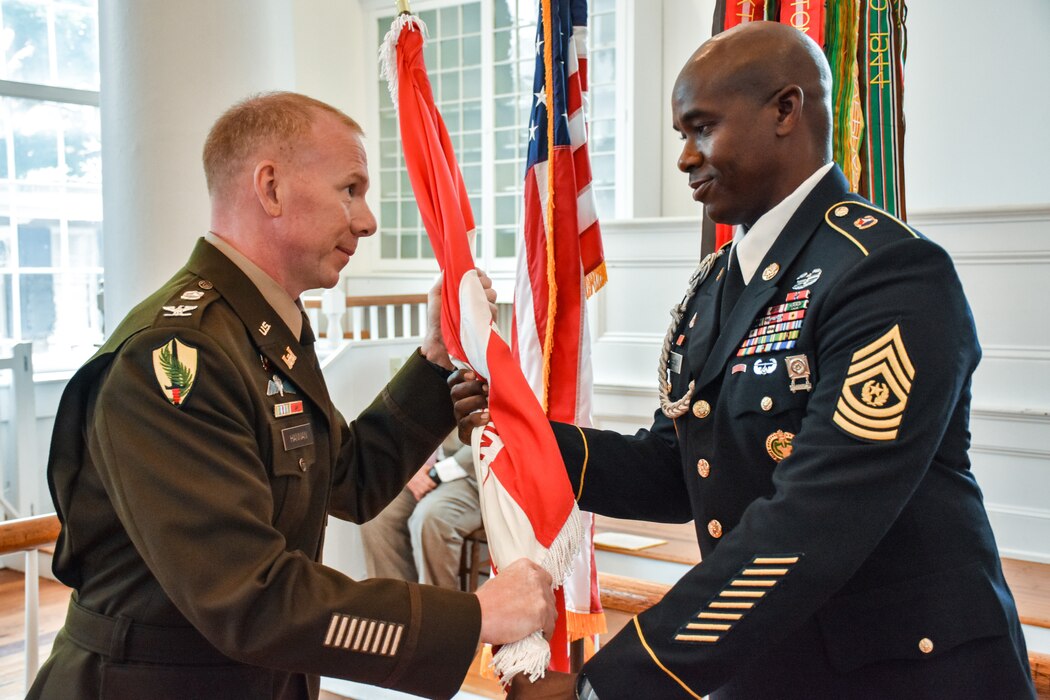 U.S. Army Col. William C. Hannan, Jr., incoming U.S. Army Corps of Engineers Transatlantic Division commander, passes the colors to Command Sgt. Maj. Clifton D. Morehouse, Transatlantic Division command sergeant major, during the change of command ceremony.