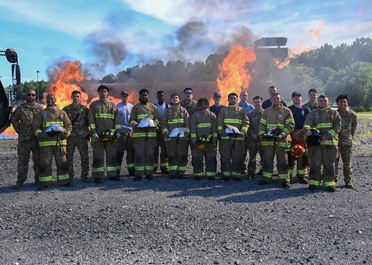 The 2022 Fire Explorer Program cadets and instructors, 316th Civil Engineer Squadron firefighters, pose for a photo at Joint Base Andrews, Md., July 30, 2022.