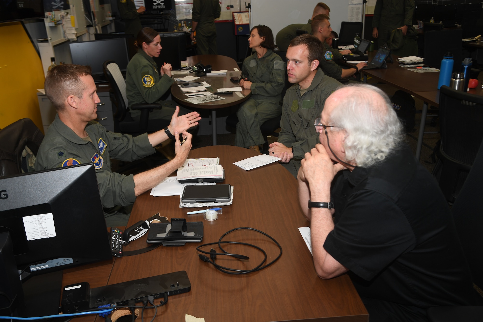 Maj. Bryan Presler accompanied by Leonard "Dr. Love" Jones receive a preflight briefing