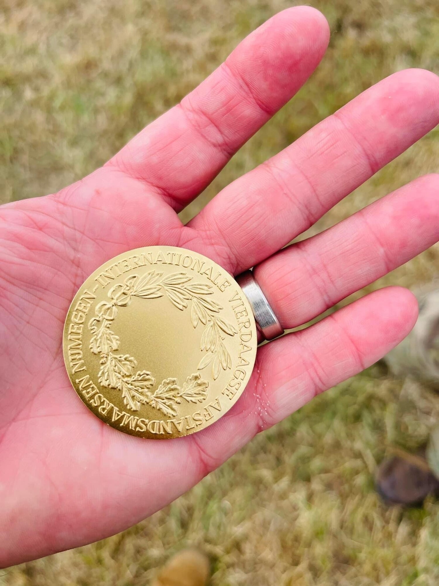 Dyess Air Force Base Rapid Airman Development Airman holds the Internationale Vierdaagse Afstandsmarsen Nijmegen Coin in honor of the team completing the the 4-Daagse March in Nijmegen, the Netherlands July 22, 2022. (U.S. Air Force Photo By 1st Lt Kaitlin Cashin)