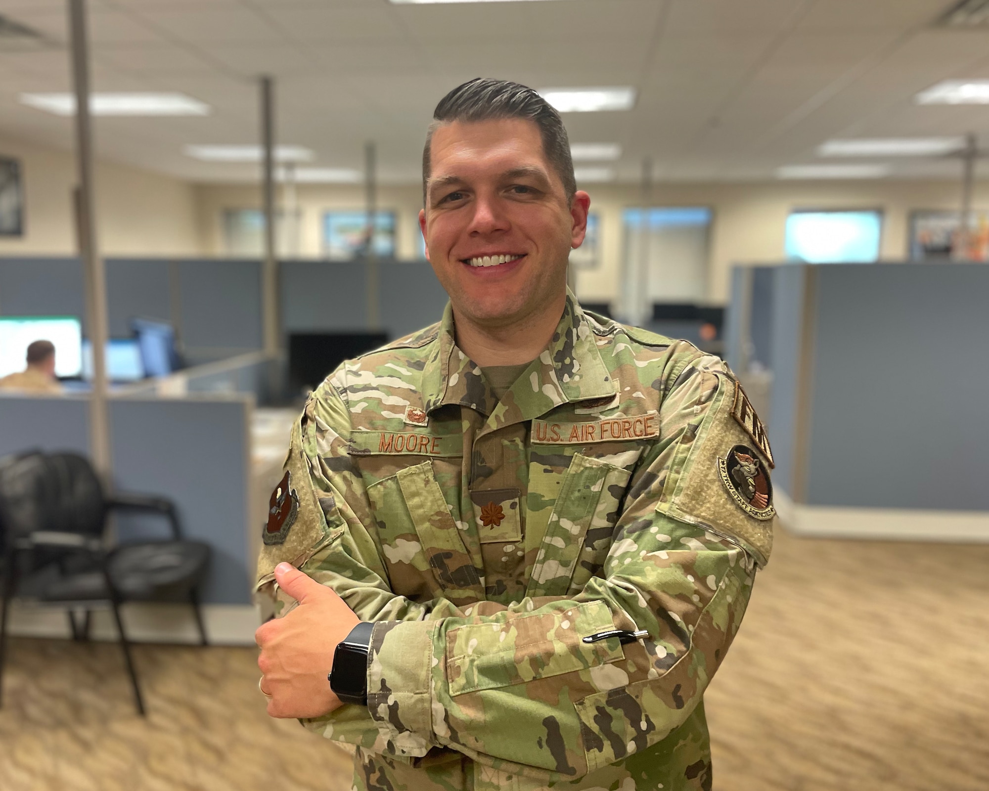 U.S. Air Force Maj. Justin Moore, 17th Comptroller Squadron and 17th Wing Staff Agencies commander, poses for a photo in the finance office at Goodfellow Air Force Base, Texas, June 24, 2022. Moore and his wife Lindsey, have a four-month-old son, Luka. (U.S. Air Force photo by Senior Airman Abbey Rieves)