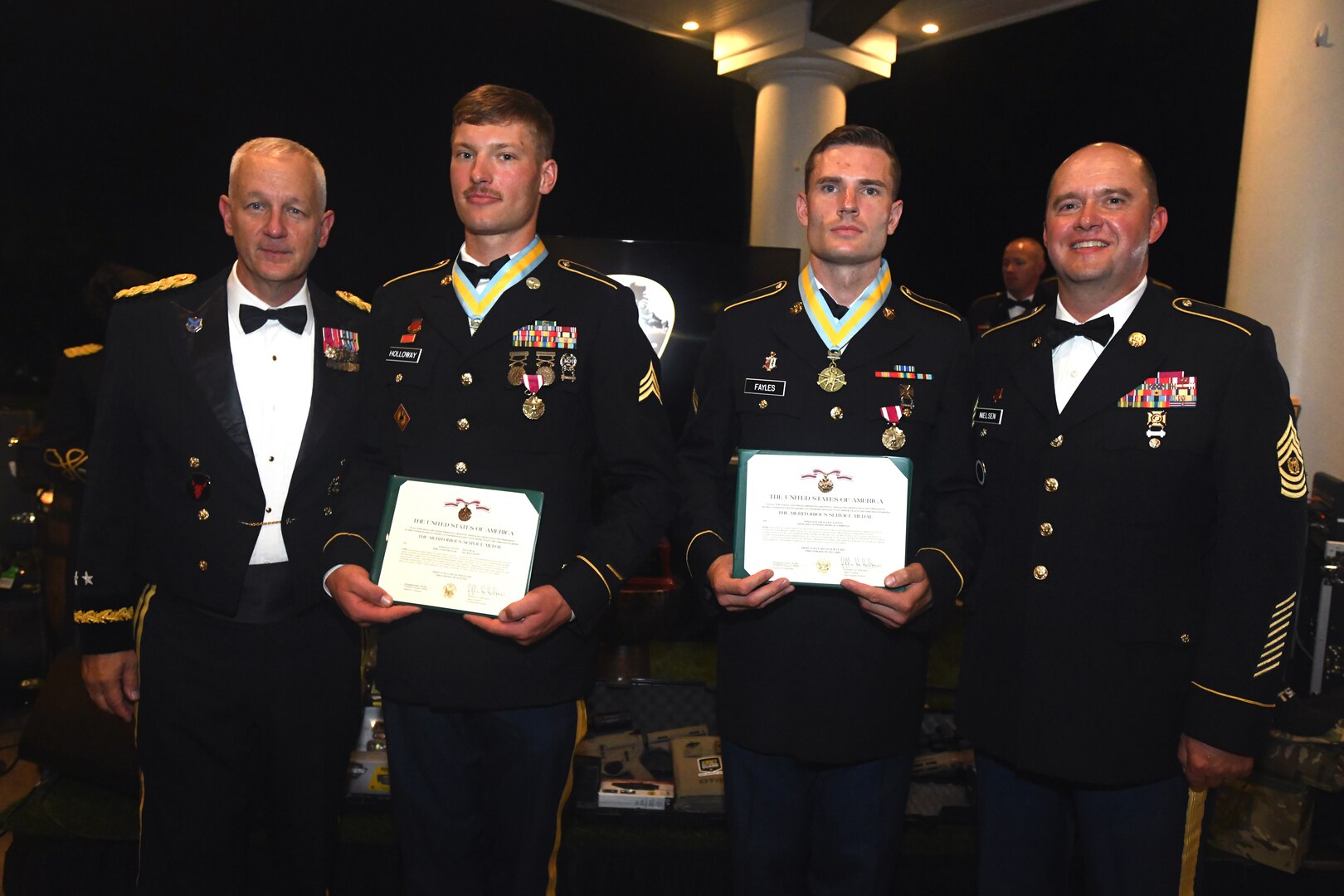 From left to right, Army Lt. Gen. Jon A. Jensen, director of the Army National Guard, Sgt. Tyler Holloway, with the Wyoming Army National Guard, Sgt. Spencer Fayles, with the Utah Army National Guard and Command Sgt Maj. Spencer Nielsen, senior enlisted leader of the Utah National Guard, showcase Holloway and Fayles’ Meritorious Service Medal awards during the closing ceremony of the 2022 Army National Guard Best Warrior Competition in Nashville, Tennessee, July 29, 2022.