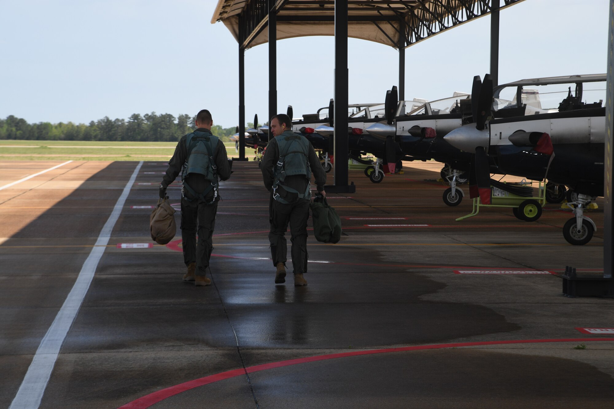 Maj. Bryan Presler steps out with his pilot to receive an orientation flight in a T-6 Texan